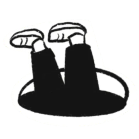 A pair of legs in black trousers and sneakers sticking up out of a black hole.
