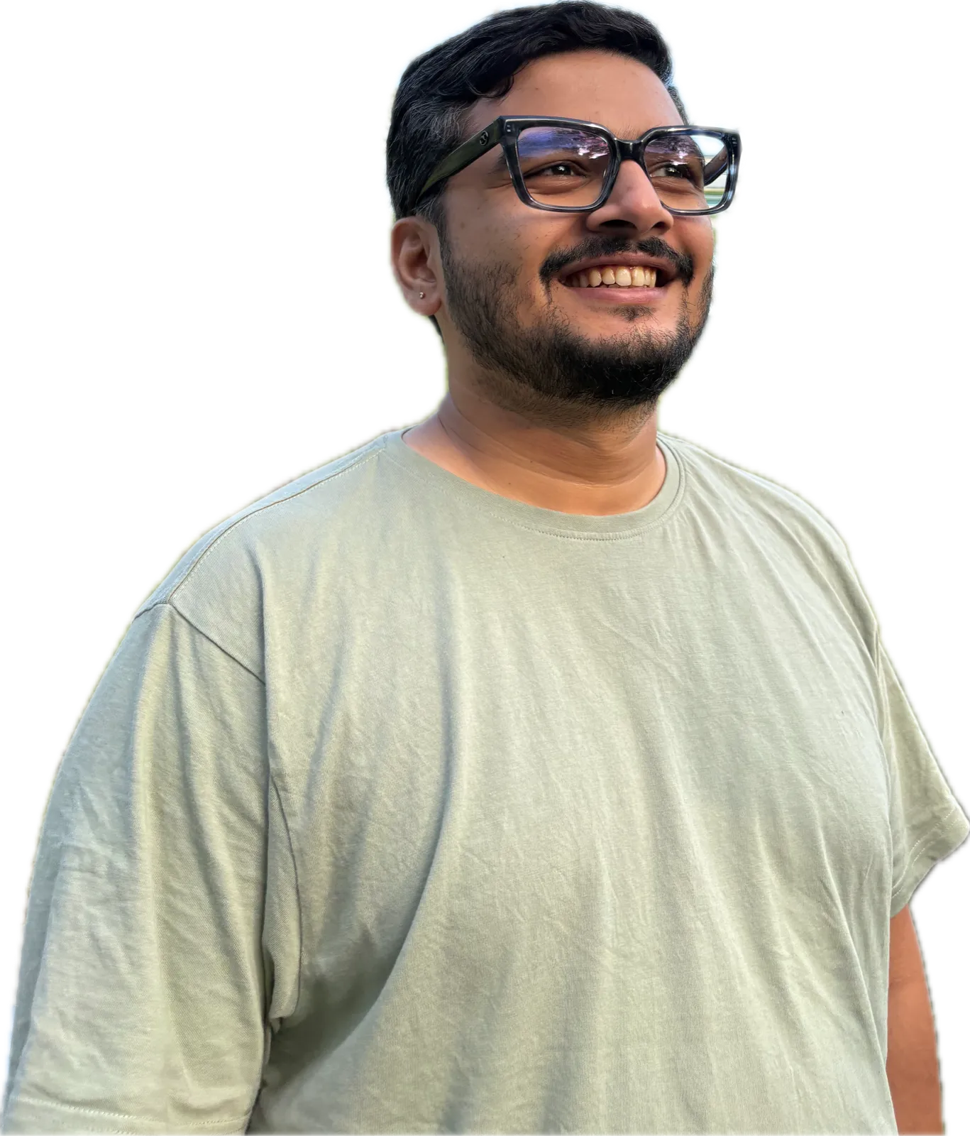 Suhruth Simha smiling, in glasses and a sage T-shirt
